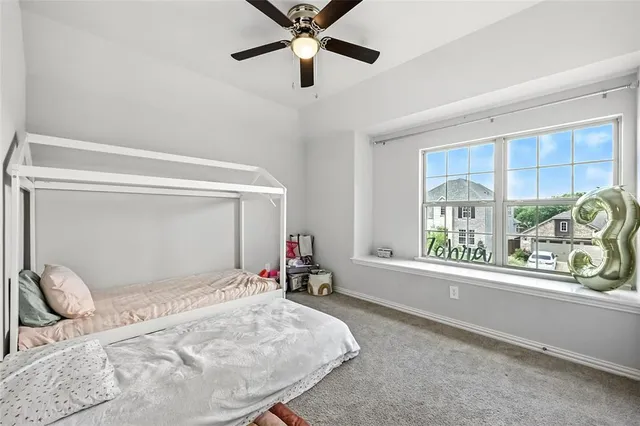 a bedroom with a bed and a large window