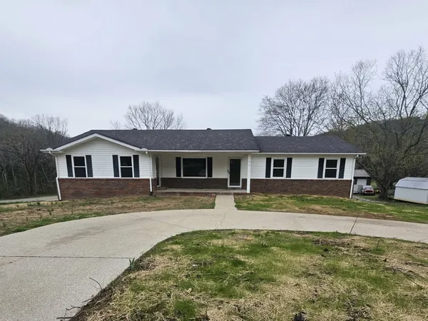 a view of a hallway with wooden floor and white cabinet