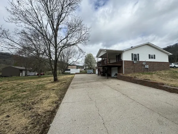 a view of a house with a yard covered in snow