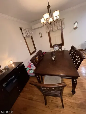 a room with table chairs and wooden floor