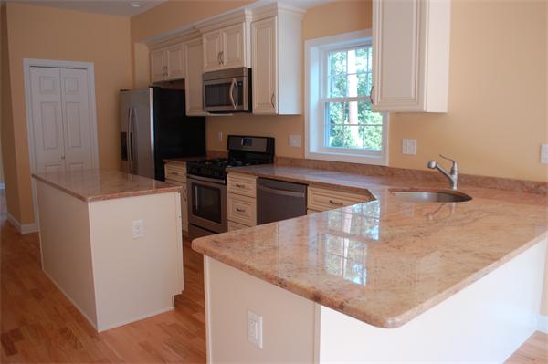 170 Beach Road, Unit U27 Salisbury, MA 01952 - Photo 3 of 4 a kitchen with stainless steel appliances granite countertop a sink stove and refrigerator