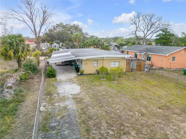 a view of a house with a yard and sitting area