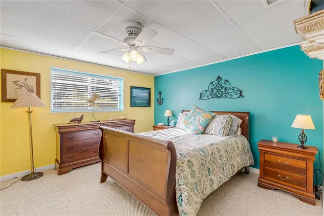a spacious bedroom with a bed and a chandelier