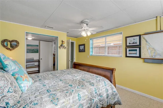 a bedroom with a bed and ceiling fan