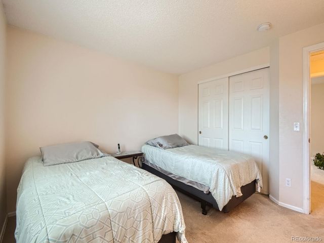 a bathroom with a granite countertop sink a toilet a mirror a bathtub and shower
