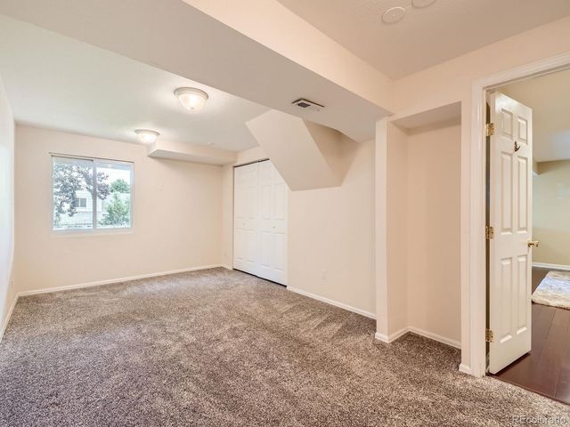 a bathroom with a granite countertop sink a toilet and a mirror