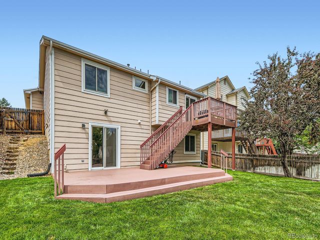 an aerial view of a house with garden space and street view