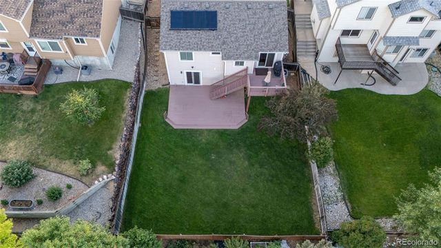 an aerial view of multiple houses with yard