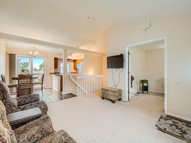 a view of a livingroom with furniture and a flat screen tv