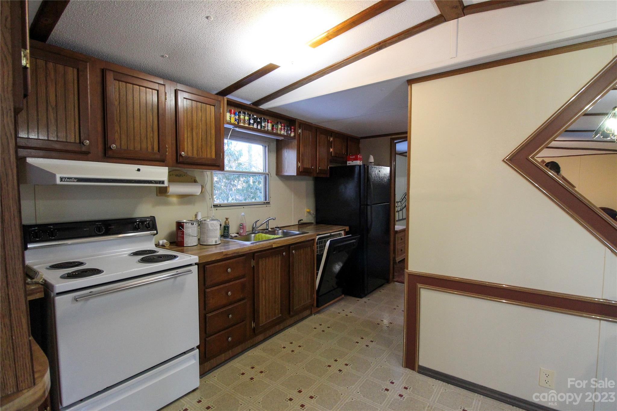 591 Pine Run Ridge Spruce Pine, NC 28777 - Photo 4 of 19 a kitchen with stainless steel appliances granite countertop a stove a refrigerator and a sink