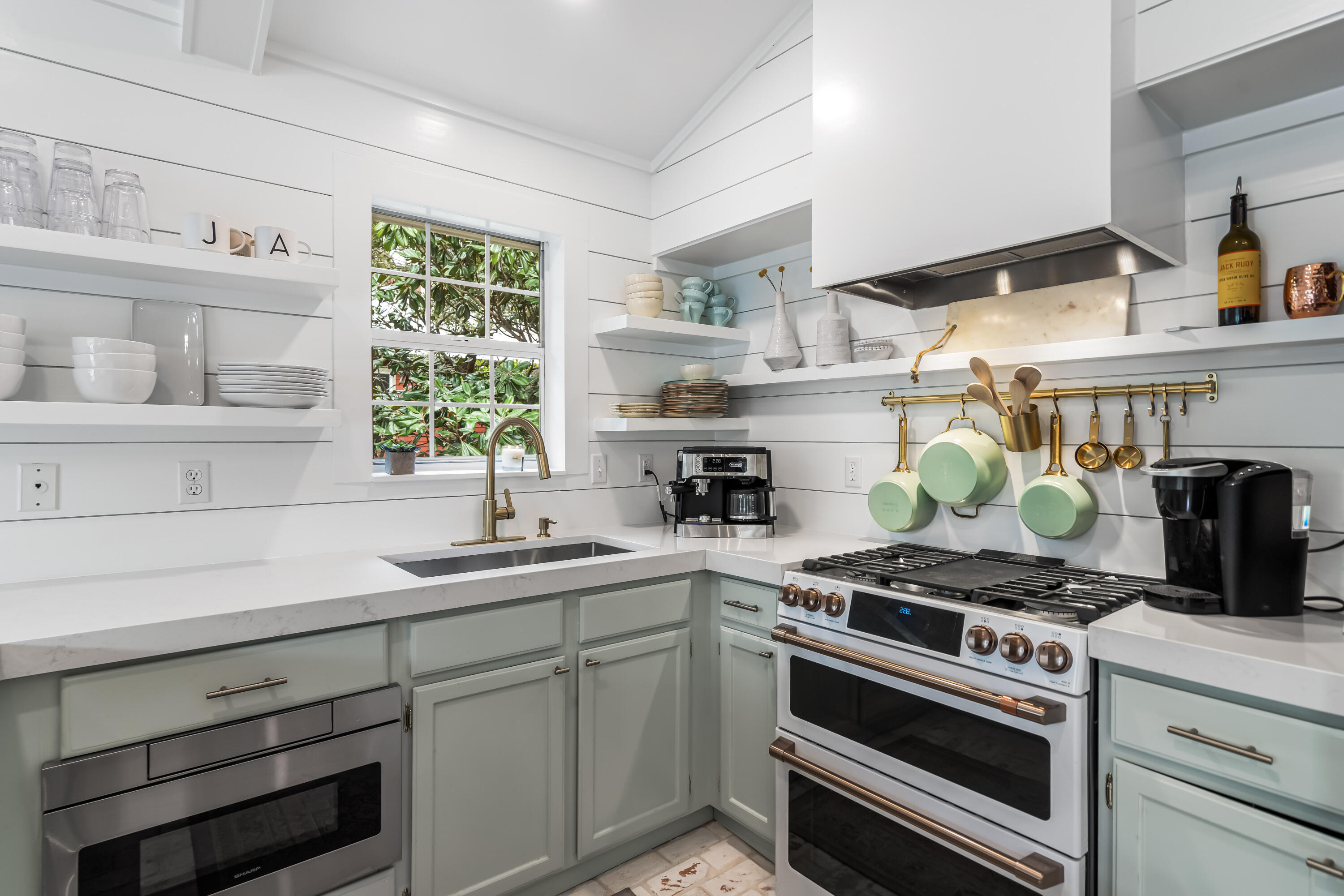 345 Defuniak Street Santa Rosa Beach, FL 32459 - Photo 12 of 52 a kitchen with stainless steel appliances white cabinets and a stove