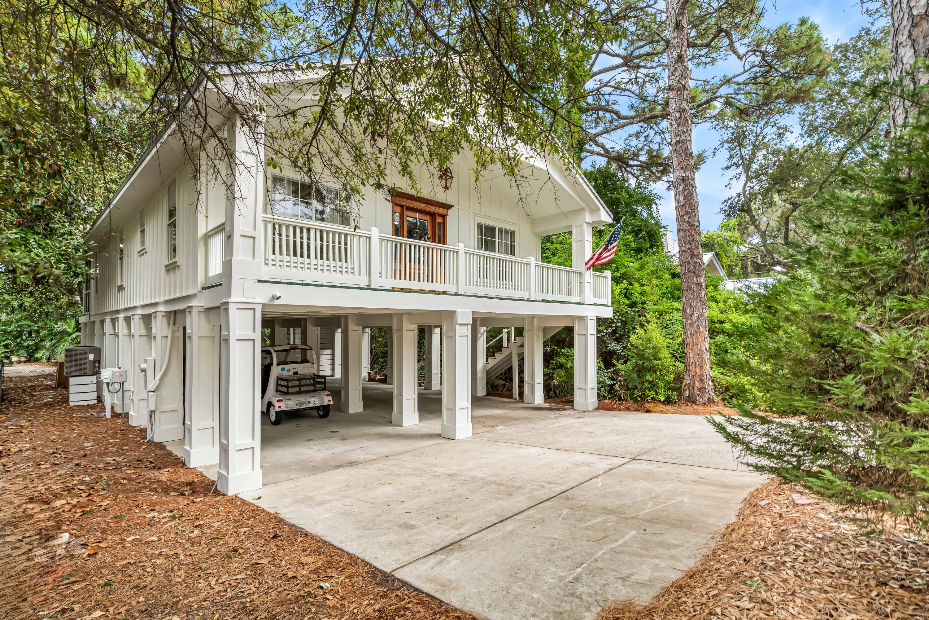 345 Defuniak Street Santa Rosa Beach, FL 32459 - Photo 2 of 52 a view of a white house with a large windows