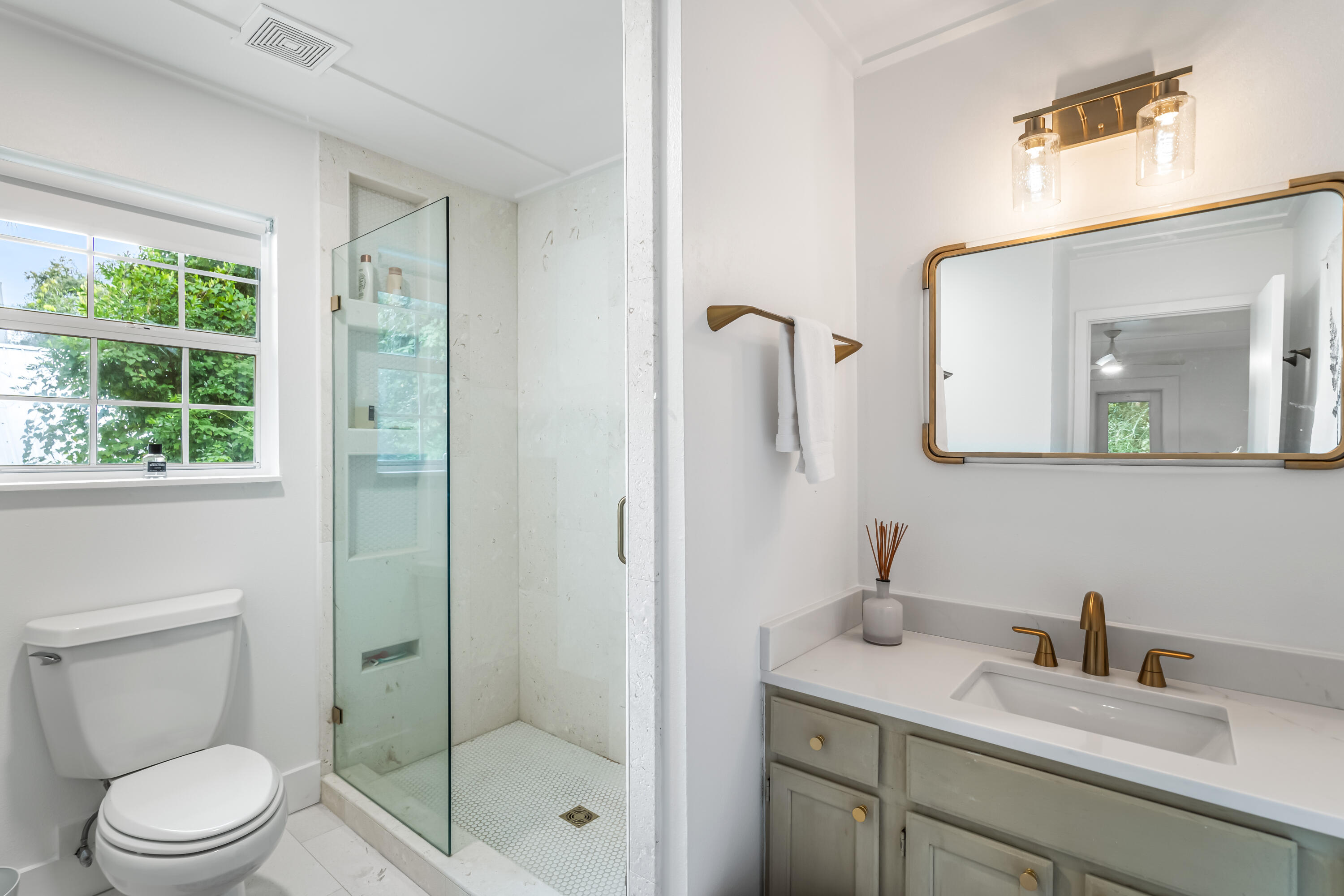 345 Defuniak Street Santa Rosa Beach, FL 32459 - Photo 28 of 52 a bathroom with a granite countertop sink a toilet and a mirror