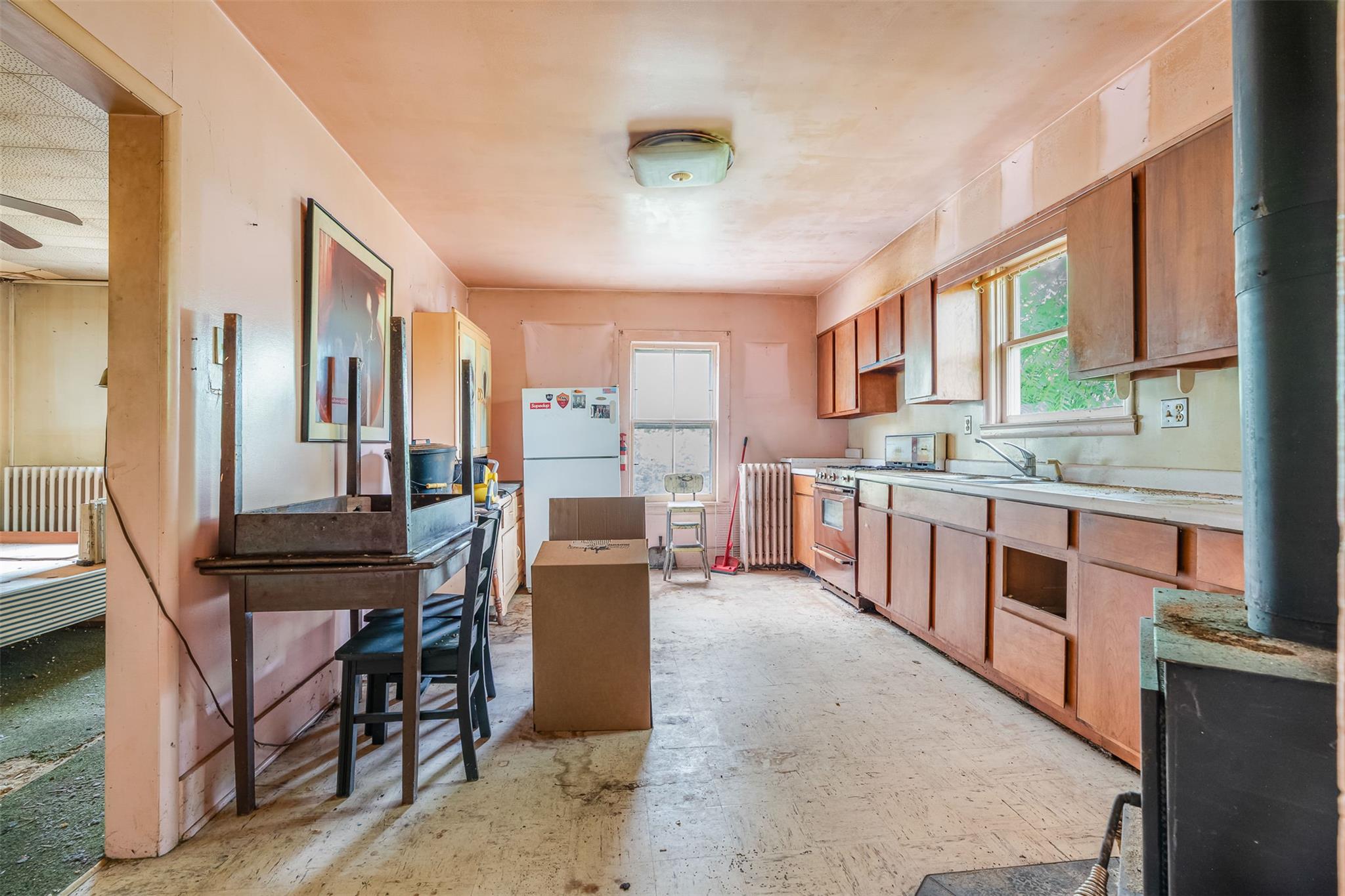 50 Maple Street Catskill, NY 12414 - Photo 12 of 27 a kitchen with stainless steel appliances kitchen island granite countertop a table chairs and a refrigerator