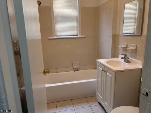 a white bath tub sitting next to a white sink