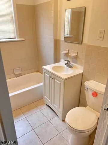 a bathroom with a sink a toilet and bathtub
