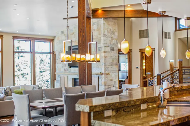 a dining area with a table and chairs