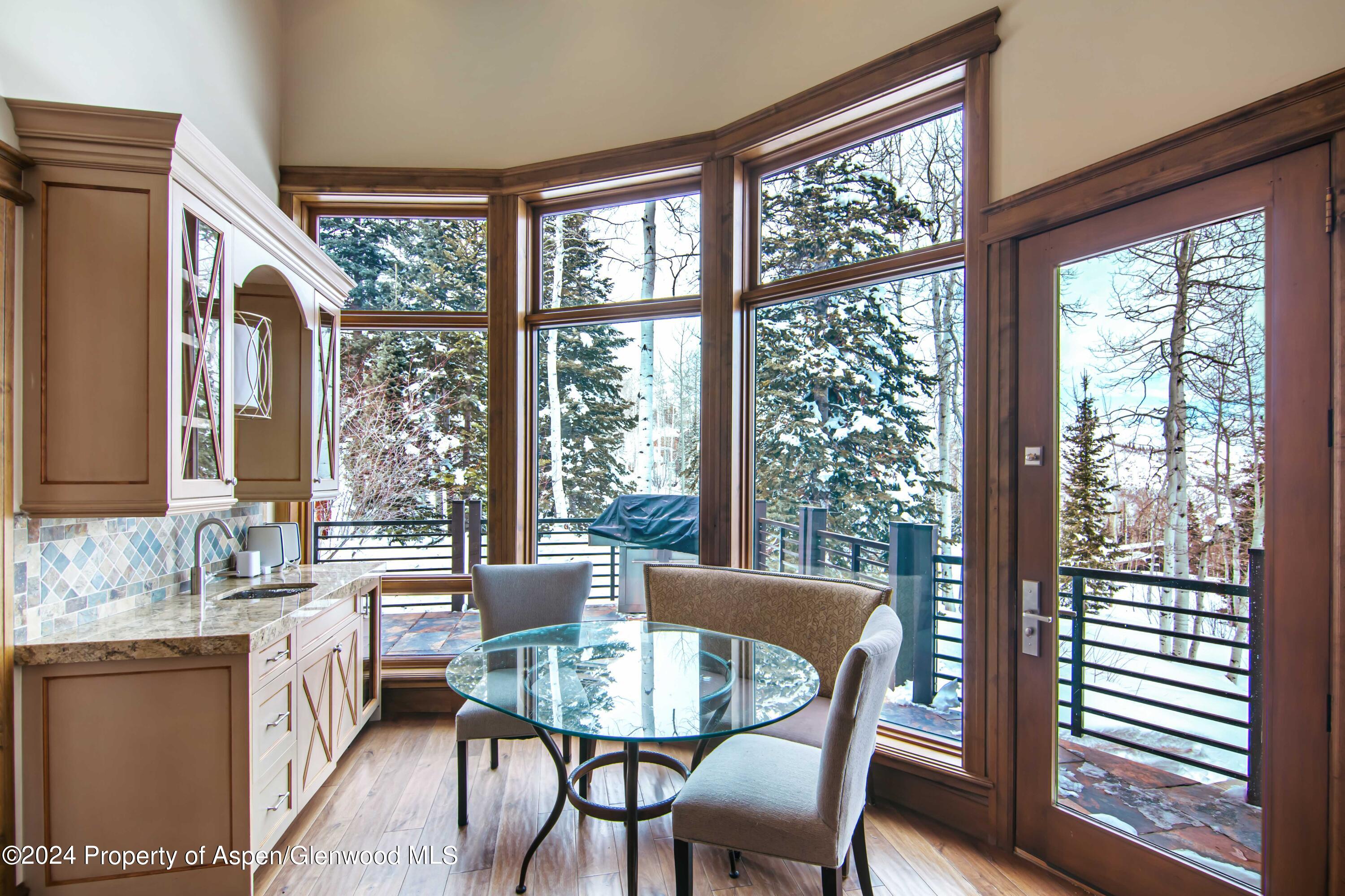 1457 Wood Road Snowmass Village, CO 81615 - Photo 18 of 70 a view of a dining room with furniture window and outside view