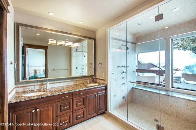 a bedroom with a bed and a lamp with wooden floor