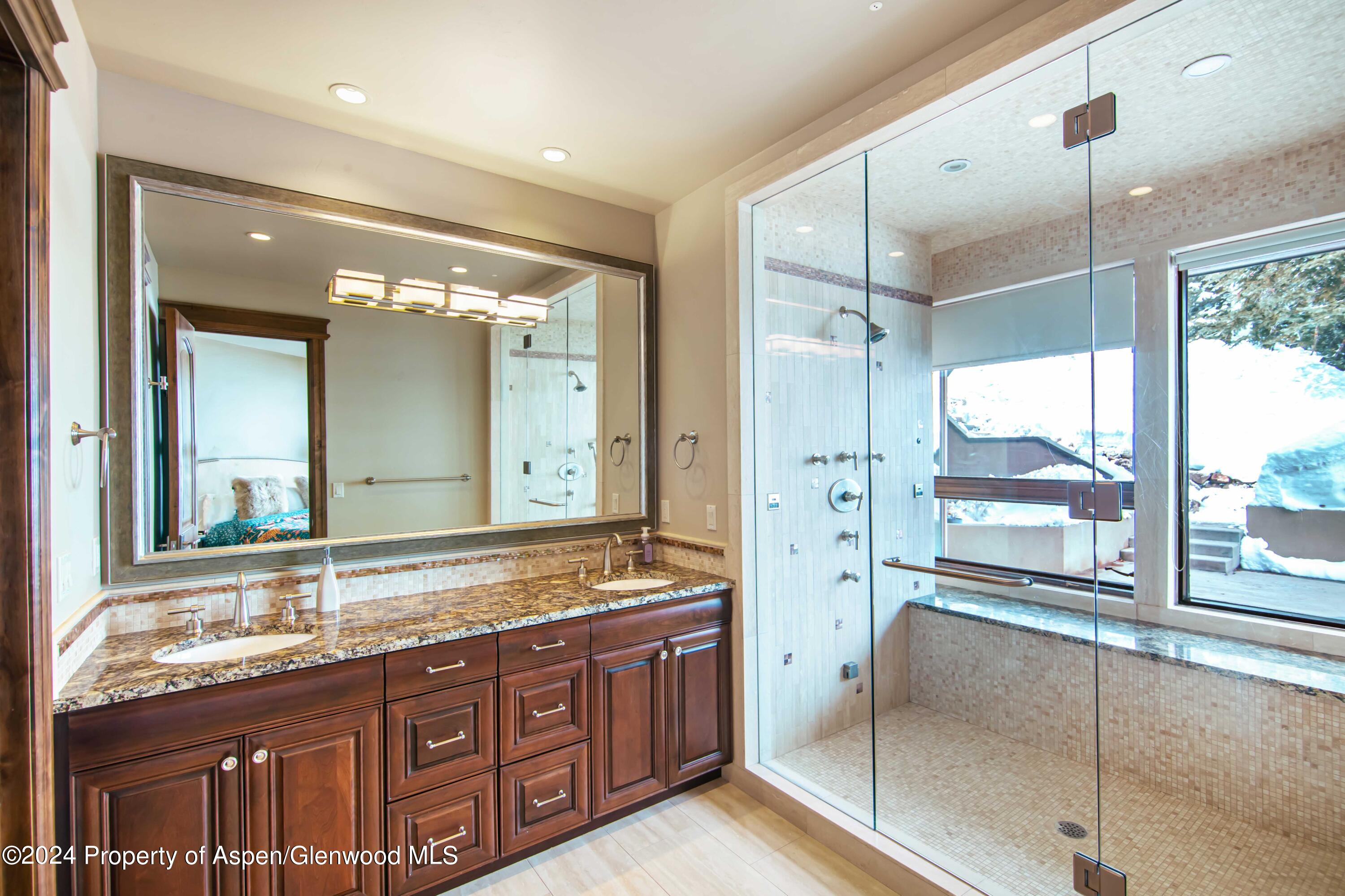 1457 Wood Road Snowmass Village, CO 81615 - Photo 26 of 70 a bathroom with a granite countertop sink mirror and double