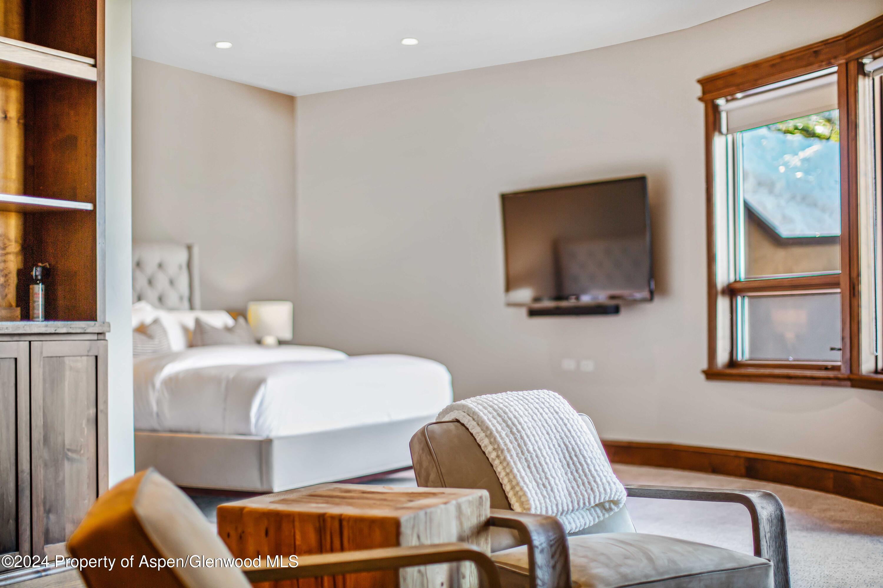 1457 Wood Road Snowmass Village, CO 81615 - Photo 31 of 70 a bedroom with furniture and a window