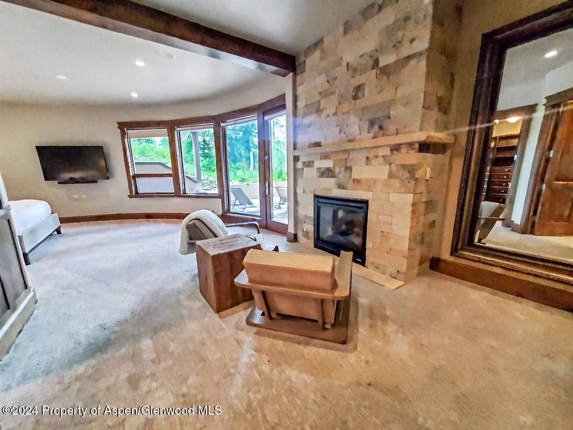1457 Wood Road Snowmass Village, CO 81615 - Photo 32 of 70 a living room with furniture and a fireplace