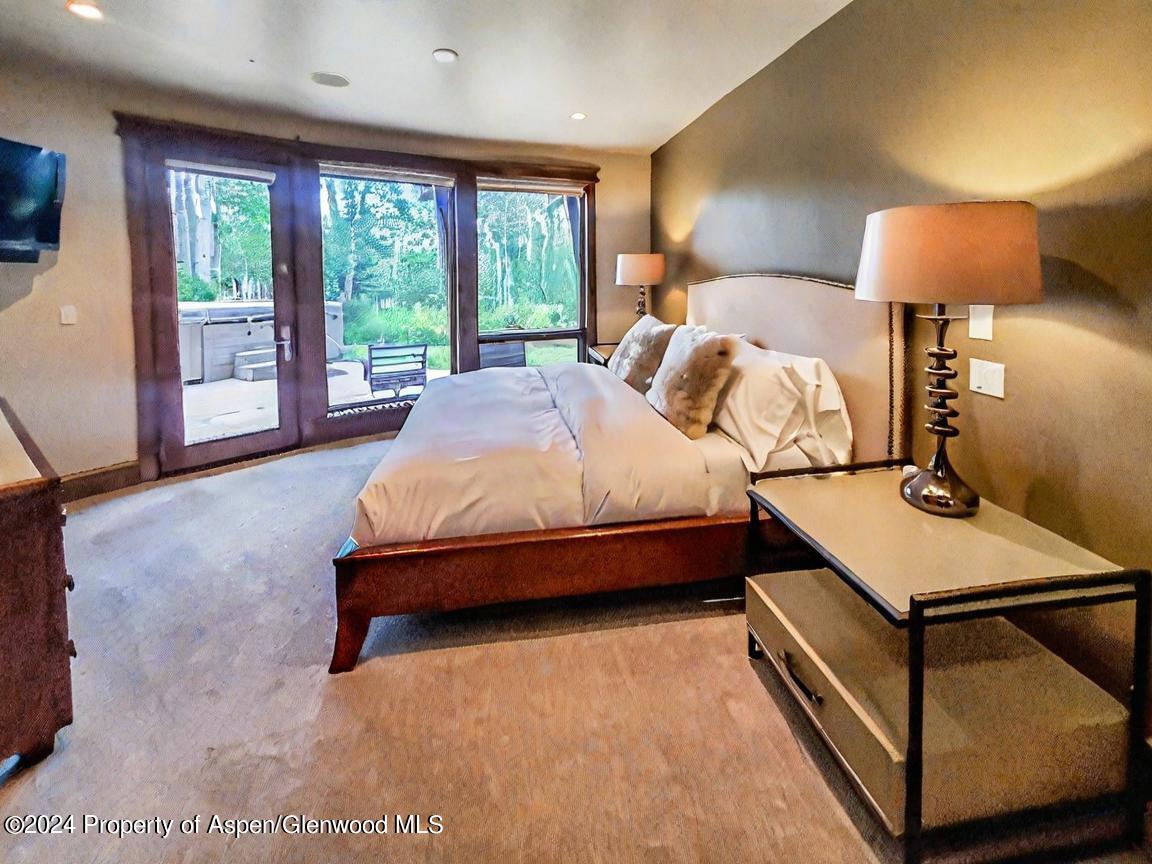 1457 Wood Road Snowmass Village, CO 81615 - Photo 34 of 70 a bed room with a bed and a night stand