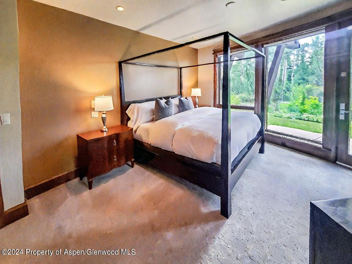 1457 Wood Road Snowmass Village, CO 81615 - Photo 35 of 70 a bed sitting in a room next to a window