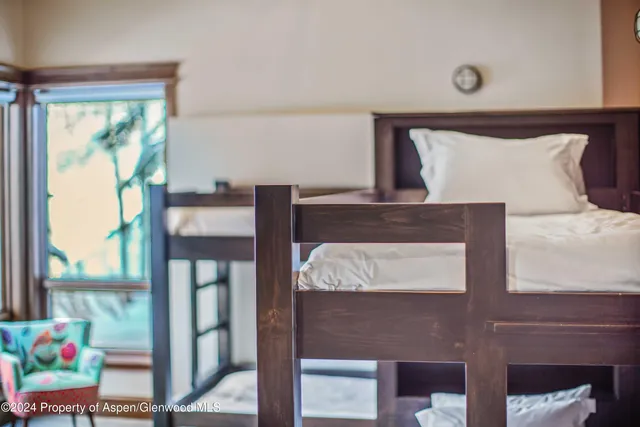 a view of hall way with furniture and paintings on the wall