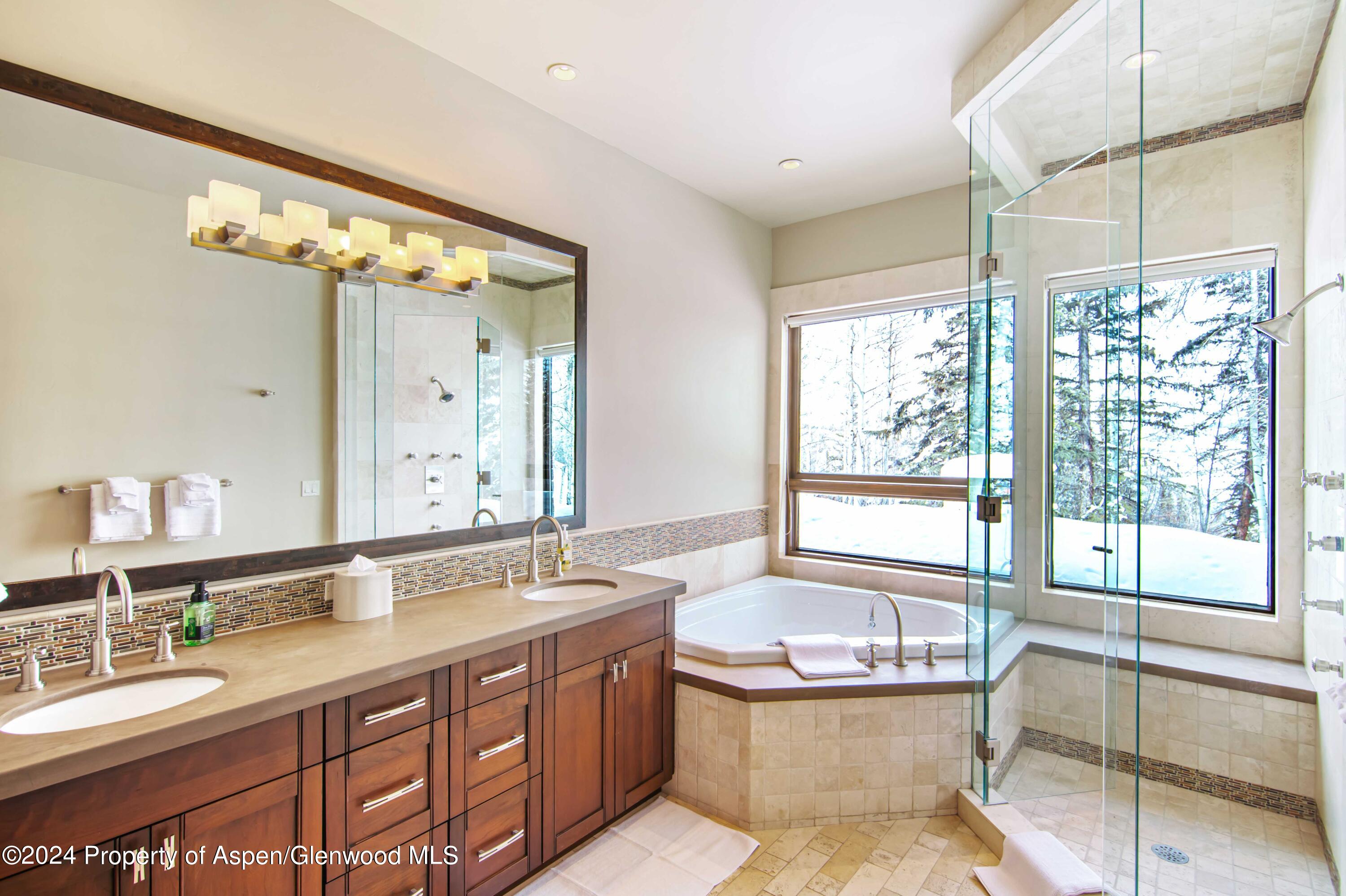 1457 Wood Road Snowmass Village, CO 81615 - Photo 41 of 70 a bathroom with a granite countertop tub double vanity and window