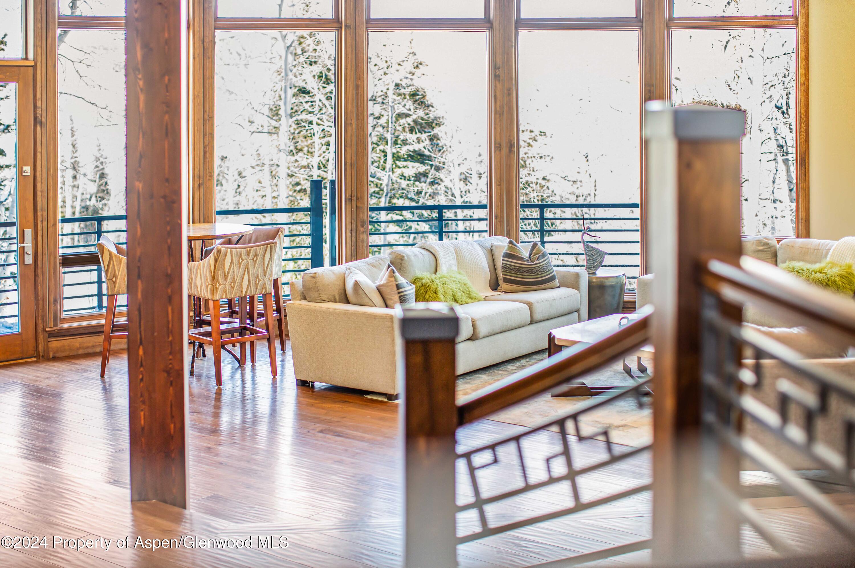 1457 Wood Road Snowmass Village, CO 81615 - Photo 55 of 70 a living room with furniture and a table with wooden floor