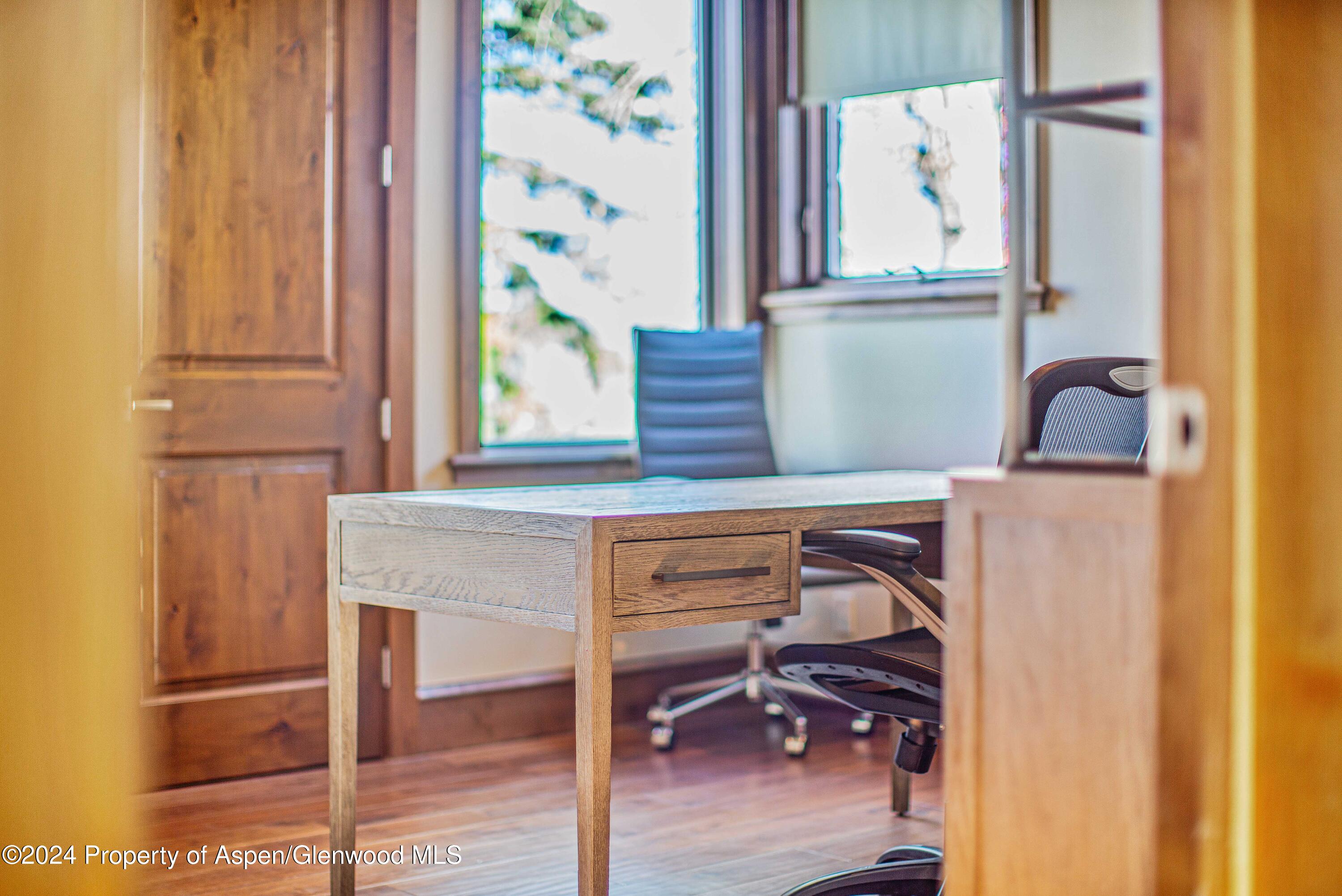 1457 Wood Road Snowmass Village, CO 81615 - Photo 58 of 70 a view of hall way with furniture and paintings on the wall