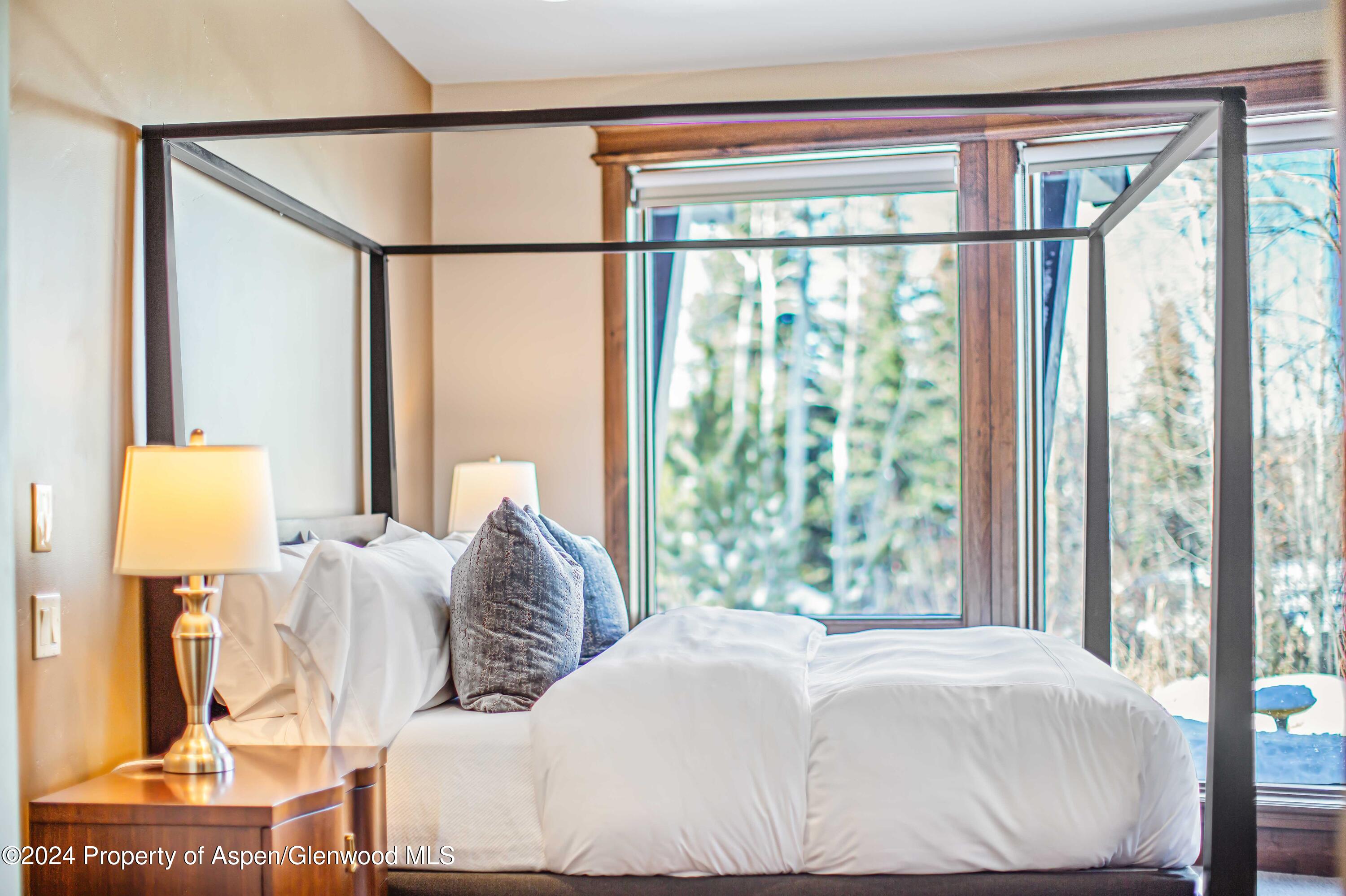 1457 Wood Road Snowmass Village, CO 81615 - Photo 63 of 70 a bedroom with a large bed and a window