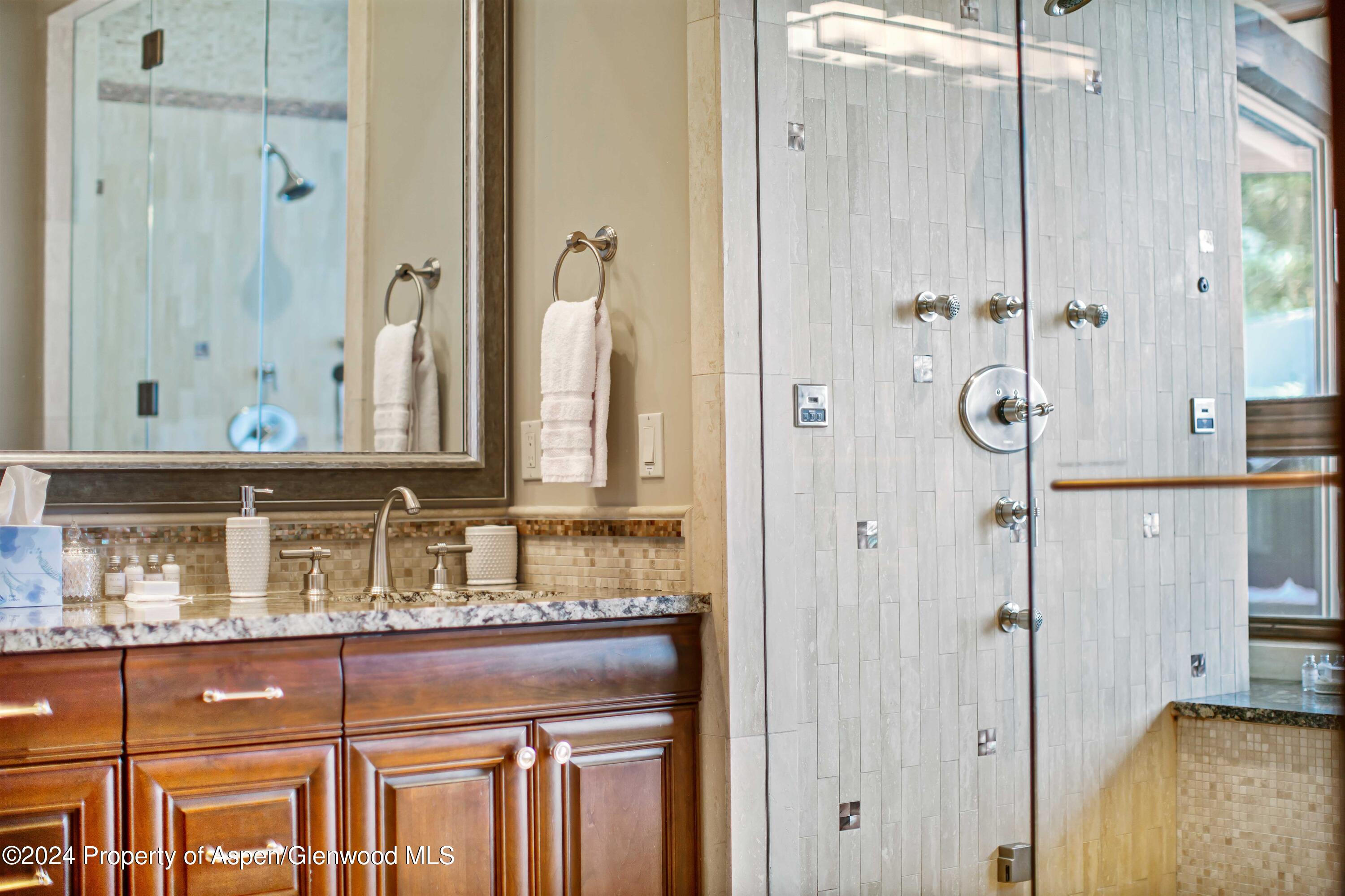 1457 Wood Road Snowmass Village, CO 81615 - Photo 66 of 70 a bathroom with a granite countertop sink and a mirror