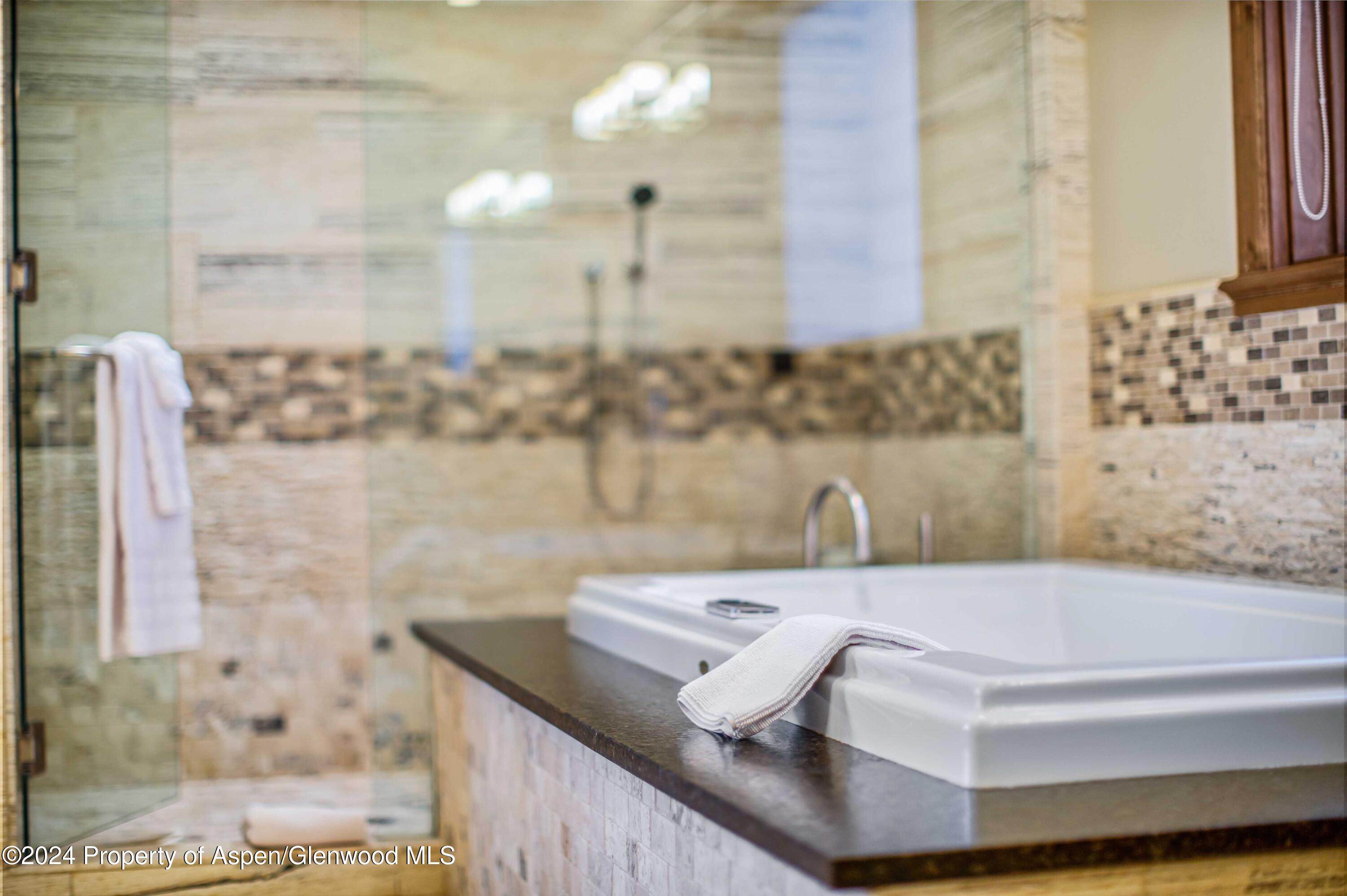 1457 Wood Road Snowmass Village, CO 81615 - Photo 69 of 70 a bath tub sitting next to a bathroom