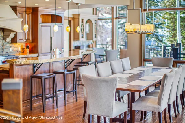 a view of a yard with plants and large trees