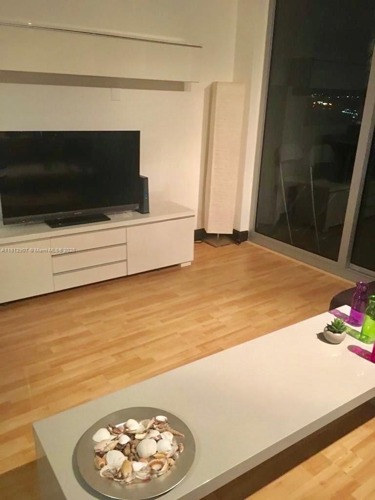 1500 Bay Road, Unit 644S Miami Beach, FL 33139 - Photo 14 of 24 a living room with a flat screen tv