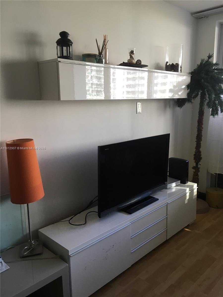 1500 Bay Road, Unit 644S Miami Beach, FL 33139 - Photo 15 of 24 a living room with furniture and a flat screen tv