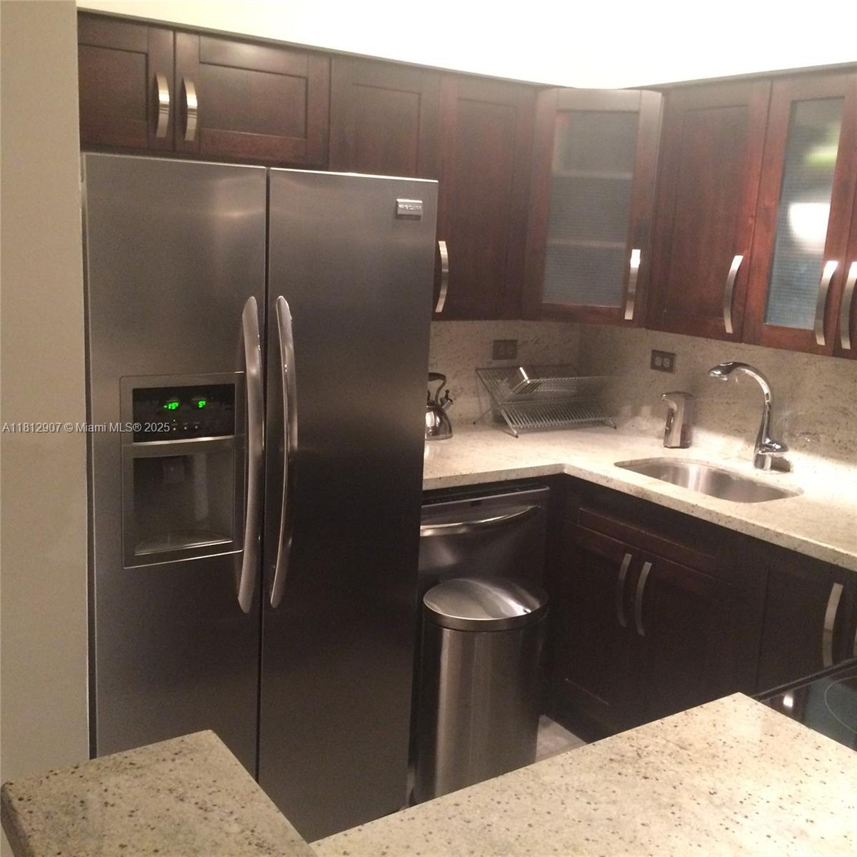 1500 Bay Road, Unit 644S Miami Beach, FL 33139 - Photo 16 of 24 a kitchen with a sink and refrigerator