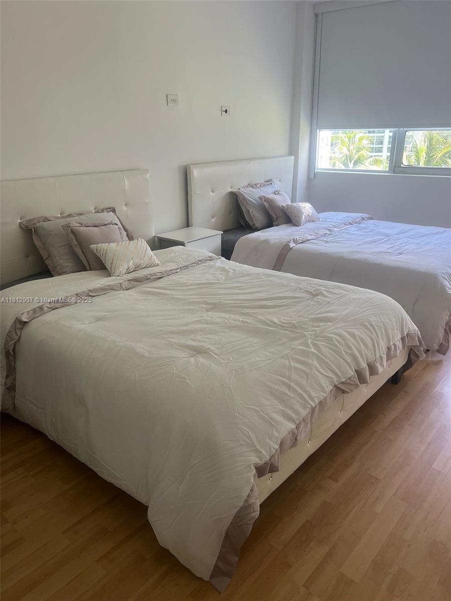 1500 Bay Road, Unit 644S Miami Beach, FL 33139 - Photo 4 of 24 a bedroom with bed and window