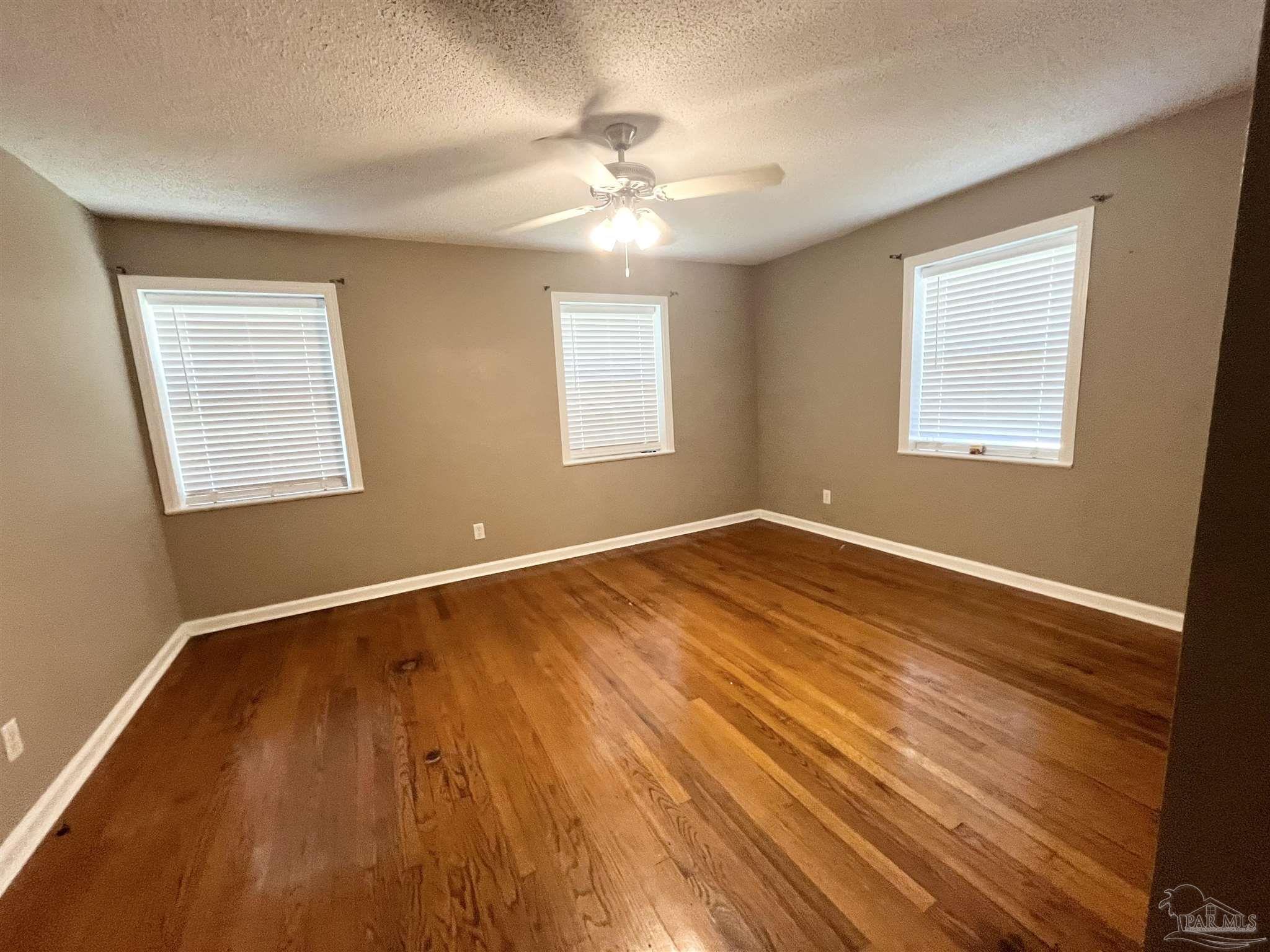 326 East Horner Street Atmore, AL 36502 - Photo 12 of 26 a view of an empty room with wooden floor and a window
