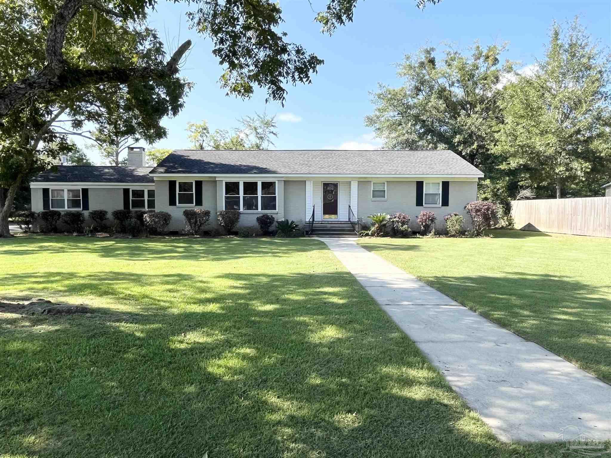 326 East Horner Street Atmore, AL 36502 - Photo 2 of 26 a view of a house with a big yard and palm trees
