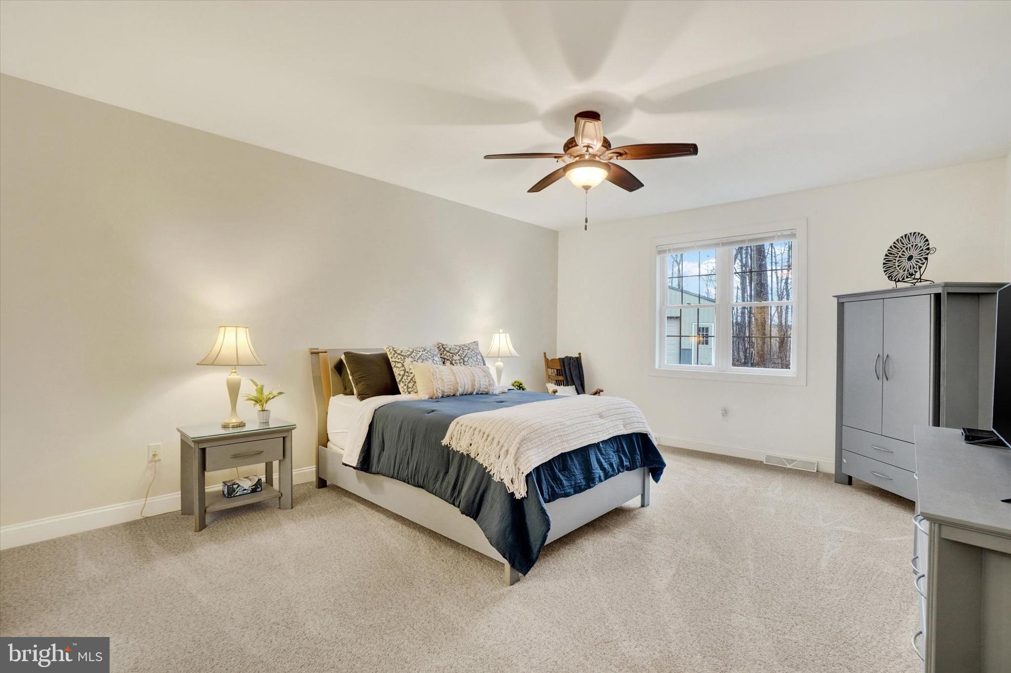 558 Rocky Road Red Lion, PA 17356 - Photo 17 of 45 a spacious bedroom with a bed painting on wall and windows