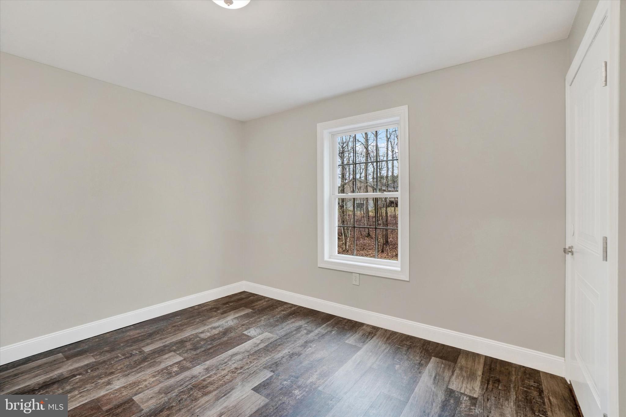 558 Rocky Road Red Lion, PA 17356 - Photo 27 of 45 an empty room with wooden floor and windows