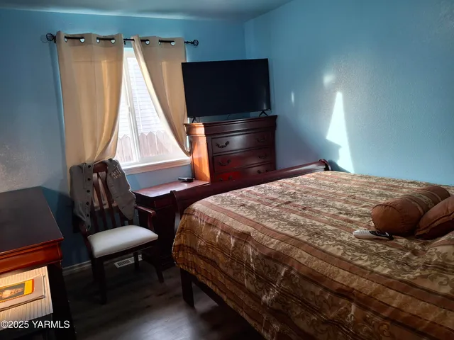 a bedroom with a bed and a chair