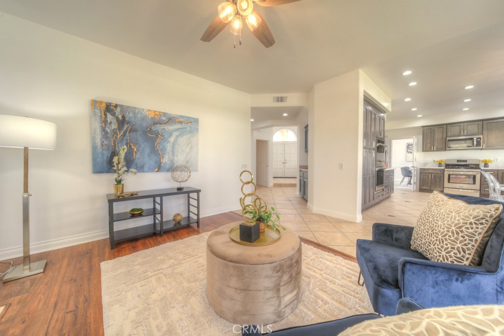 32230 Corte Chatada Temecula, CA 92592 - Photo 16 of 53 a living room with furniture and a dining table with kitchen view