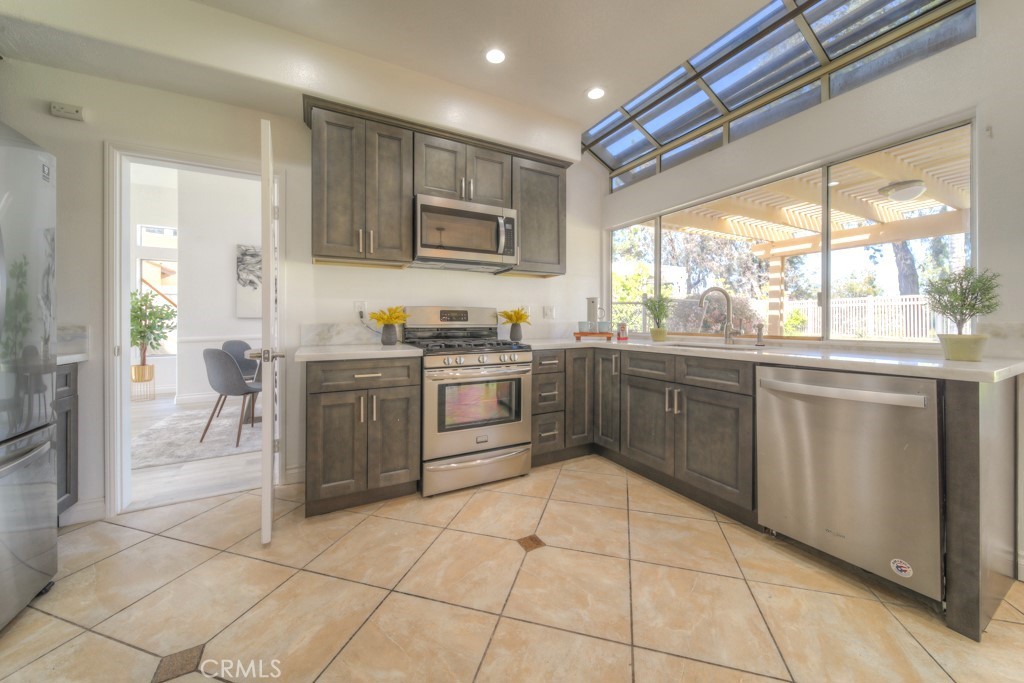 32230 Corte Chatada Temecula, CA 92592 - Photo 19 of 53 a kitchen with a sink a stove a refrigerator and a window