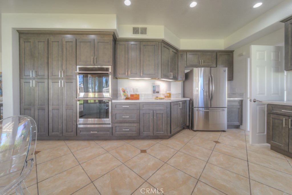 32230 Corte Chatada Temecula, CA 92592 - Photo 23 of 53 a kitchen with stainless steel appliances a refrigerator and cabinets