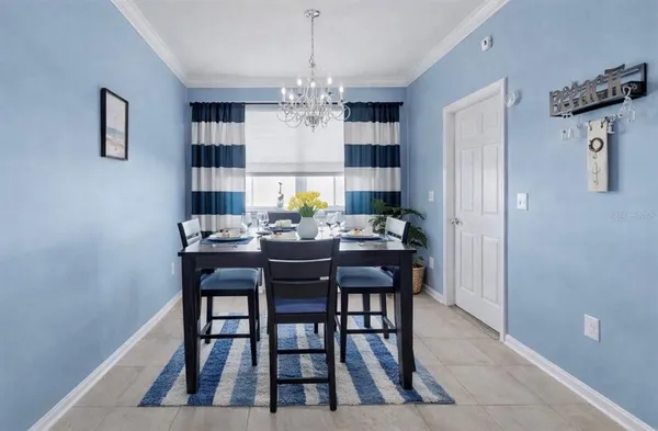 a view of a dining room with furniture and a chandelier