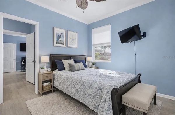 a bedroom with a bed and a flat screen tv